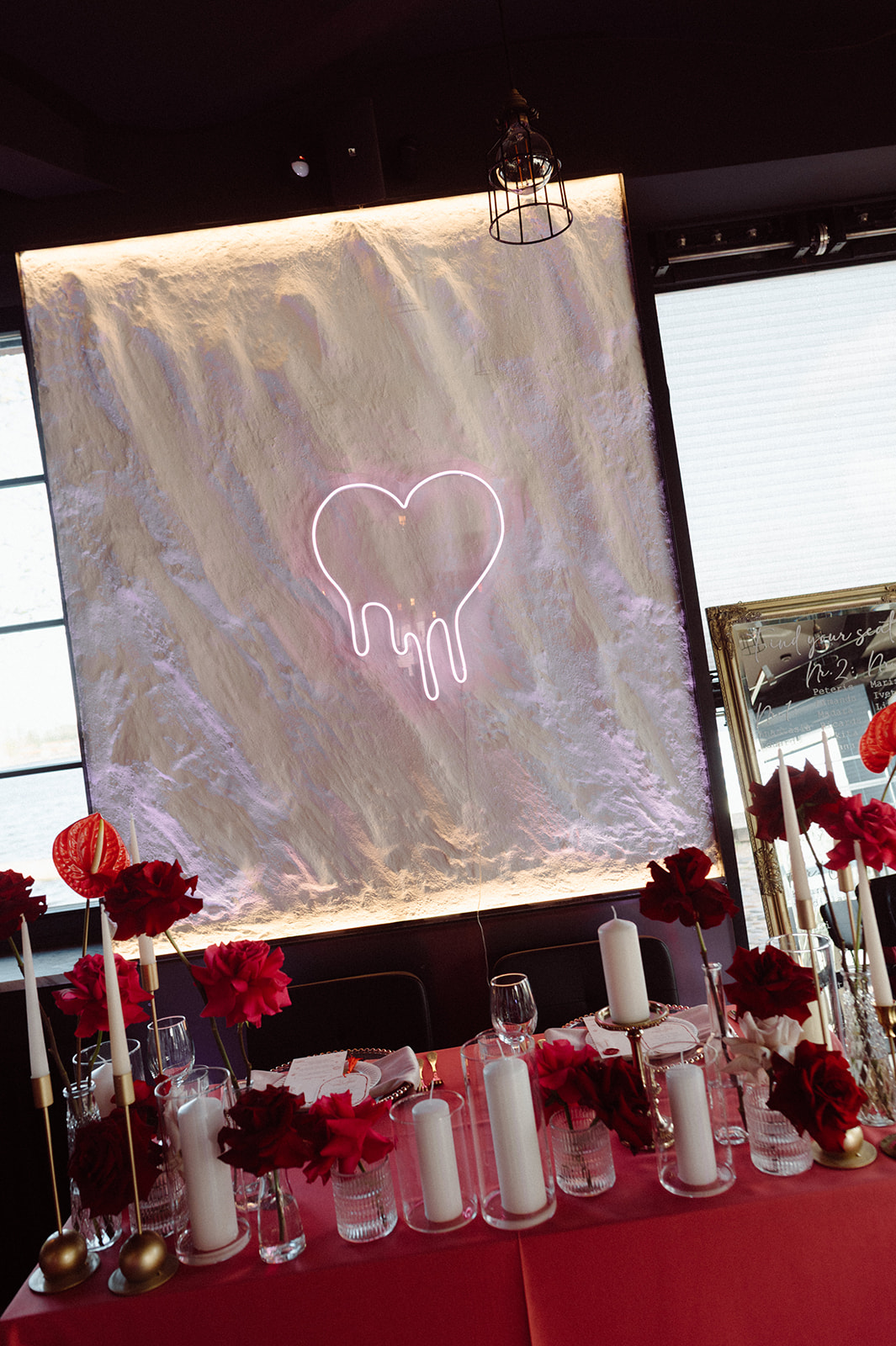 Red floral tablescape with neon backdrop